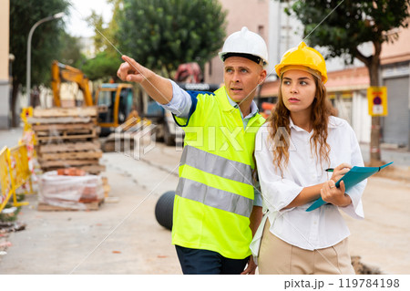 Civil engineers checking work process in construction site 119784198