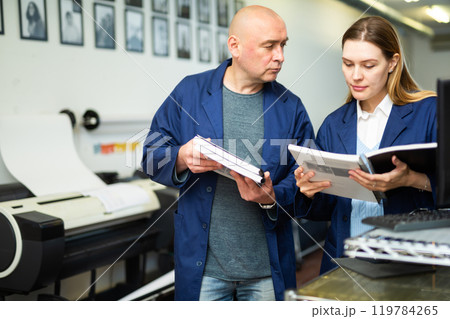 Woman printing office worker reading operation manual 119784265