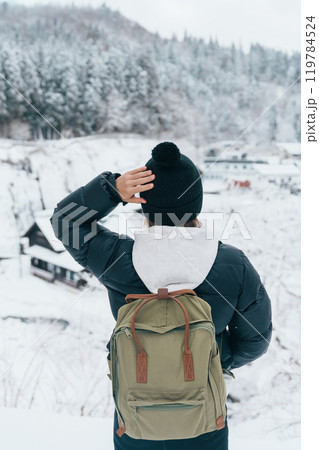 Woman tourist Visiting Ginzan Onsen in Yamagata, happy Traveler sightseeing Japanese Onsen village with Snow in winter season. landmark and popular for attraction in Japan. Travel and Vacation concept 119784524