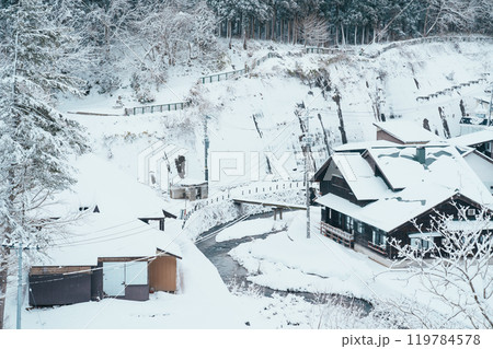 Beautiful view of Ginzan Onsen village with snow fall in winter season is most famous Japanese Hot Spring in Yamagata, Japan. 119784578
