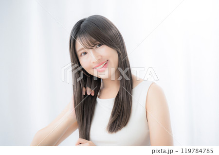 ヘアケアをする若い女性 手櫛で梳かす、ヘアオイルなどでケアをする ロングヘアの天使の輪 ヘアケアをする若い女性 手櫛で梳かす、ヘアオイルなどでケアをする ロングヘアの天使の輪 119784785