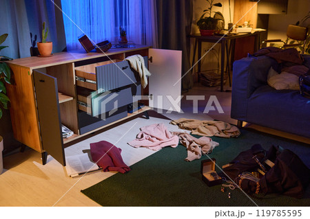Wooden opened dresser, clothes and mess on floor after break-in at late night Wooden opened dresser, clothes and mess on floor after break-in at late night 119785595