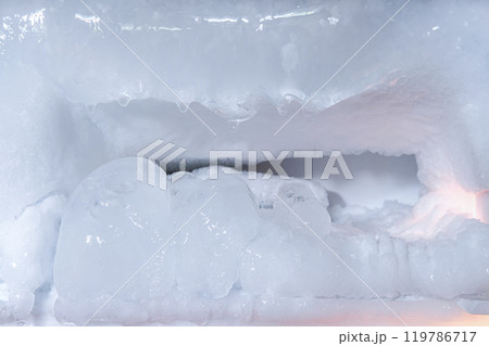 Inside a old refrigerator's freezer compartment Excessive frost buildup in the freezer Inside a old refrigerator's freezer compartment Excessive frost buildup in the freezer 119786717
