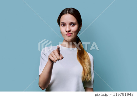 Young beautiful redhead teenage woman pointing finger you, on blue studio background. Youth, age college, advertising products goods services concept Young beautiful redhead teenage woman pointing finger you, on blue studio background. Youth, age college, advertising products goods services concept 119791948