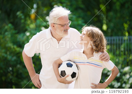 Grandfather and kids in sunny garden Grandfather and kids in sunny garden 119792193