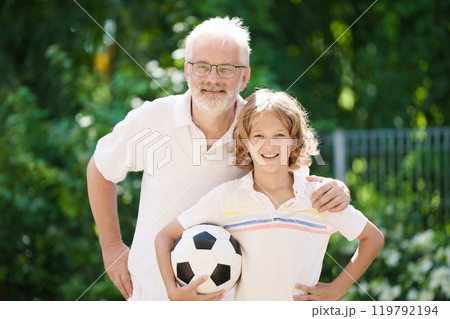 Grandfather and kids in sunny garden 119792194
