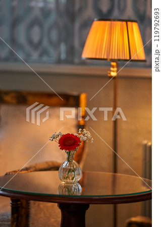 Splendid chandelier with lit candles in a beautiful room of an old mansion 119792693