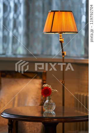 Splendid chandelier with lit candles in a beautiful room of an old mansion Splendid chandelier with lit candles in a beautiful room of an old mansion 119792704