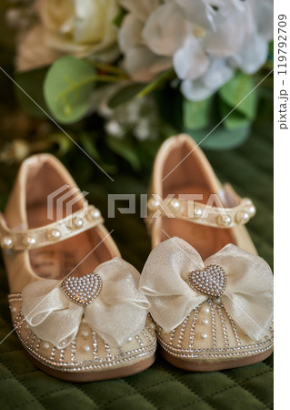 Flower girl shoes close up on the bed  119792709