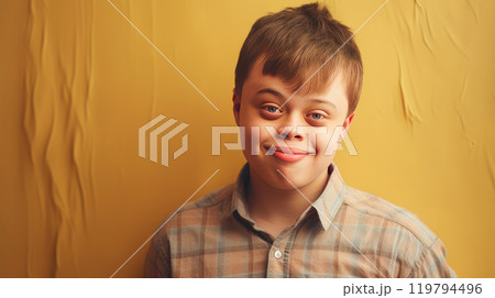 Portrait of smiling laughing teenager guy with Down syndrome creamy beige background. 119794496