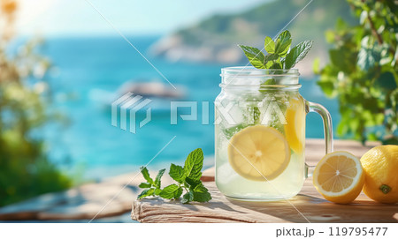 Lemonade with lemon and mint on the background of the sea. 119795477