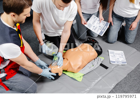 First Aid Training - Cardiopulmonary resuscitation. First aid course on cpr dummy. 119795971