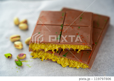 Trend Dubai chocolate with pistachio paste and kataifi dough. Confectionery handmade sweets at home in the kitchen. Trend Dubai chocolate with pistachio paste and kataifi dough. Confectionery handmade sweets at home in the kitchen. 119797806