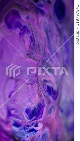 Glitter ink splash. Neon fluid. Defocused purple blue color shiny sparkling texture paint mix flow on black fantasy abstract art background. Glitter ink splash. Neon fluid. Defocused purple blue color shiny sparkling texture paint mix flow on black fantasy abstract art background. 119797841