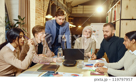 Professionals participate in business planning session, using graphs and charts for effective strategy. 119797957