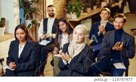 Group of attentive professionals from different backgrounds attending seminar. Moments of learning and professional development Group of attentive professionals from different backgrounds attending seminar. Moments of learning and professional development 119797977