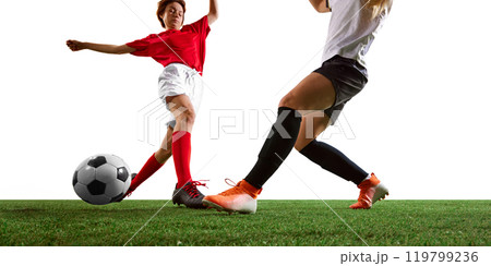 Dynamic soccer game between two determined female athletes in red and white uniforms on lush green field. 119799236