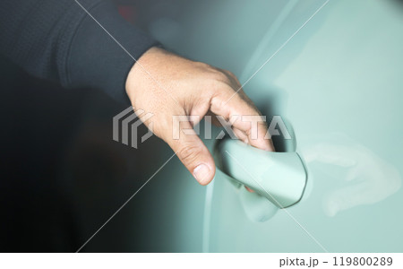 A man's hand touching the car door to unlock it without using a remote or key. Represents the concept of modern vehicle technology, highlighting keyless entry systems for convenience and security A man's hand touching the car door to unlock it without using a remote or key. Represents the concept of modern vehicle technology, highlighting keyless entry systems for convenience and security 119800289