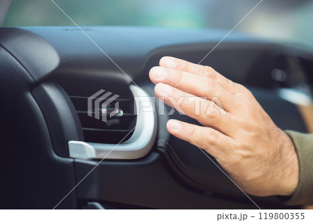 Car owner checks the air conditioning system by feeling the cool air from the vent after the vehicle has been flooded. Concept of vehicle maintenance, focusing on post-flood cooling system inspections 119800355