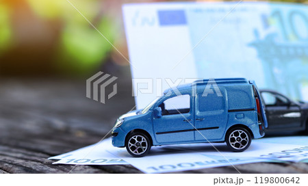 Model car with euro banknotes on blur background. Planning of saving for buying car, car loan and car insurance concept. 119800642