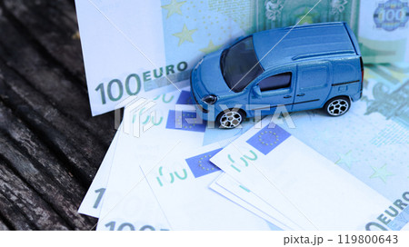 Model car with euro banknotes on blur background. Planning of saving for buying car, car loan and car insurance concept. Model car with euro banknotes on blur background. Planning of saving for buying car, car loan and car insurance concept. 119800643