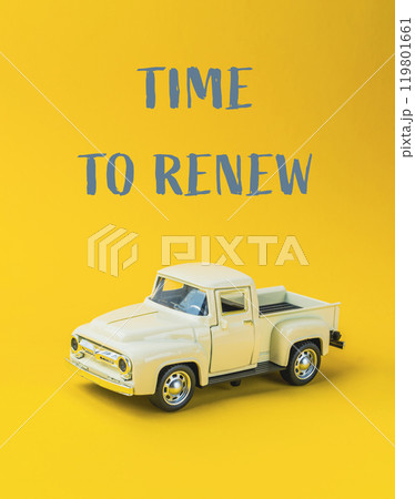A toy truck is on a yellow background with the words Time to Renew A toy truck is on a yellow background with the words Time to Renew 119801661