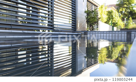 A serene twilight beach shows a sea turtles silhouette, slowly making its way to the water - peaceful beauty. 119803244