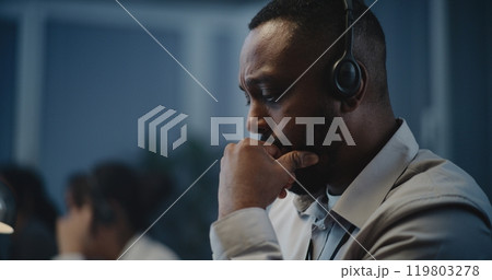 African American hotline specialist in headset providing online psychological assistance 119803278