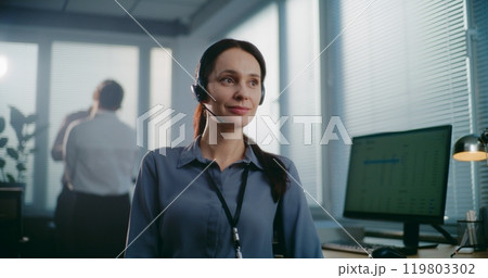 Close up portrait of friendly Caucasian female technical customer support specialist in headset 119803302