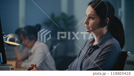 Multiethnic team of helpline operators working in call center of psychological hotline Multiethnic team of helpline operators working in call center of psychological hotline 119803428