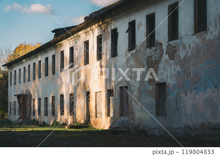 Boarded-up windows of an old abandoned building. Evening sunlight Boarded-up windows of an old abandoned building. Evening sunlight 119804833