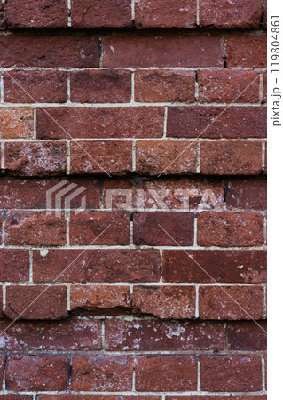 The brick wall of the castle is damaged. Brick wall background. Brick background 119804861