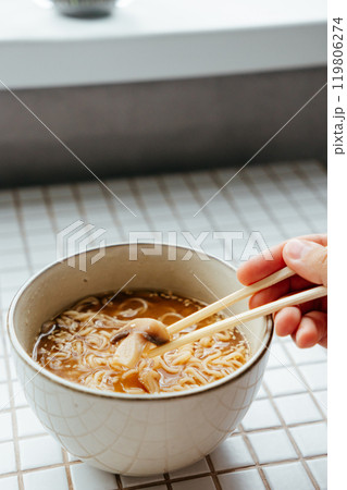 spicy instant noodles with pieces of mushrooms, green and red chili peppers and vegetables, close up spicy instant noodles with pieces of mushrooms, green and red chili peppers and vegetables, close up 119806274