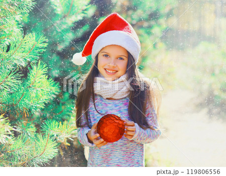 Christmas smiling child little girl in santa red hat with ball n 119806556