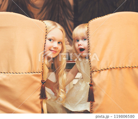 Christmas children little girls sit at the table at home 119806580