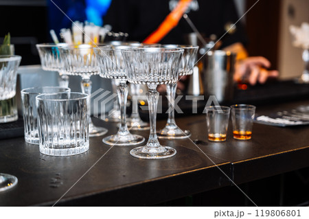 Enjoying alcohol tasting and cocktail preparation at a vibrant bar 119806801