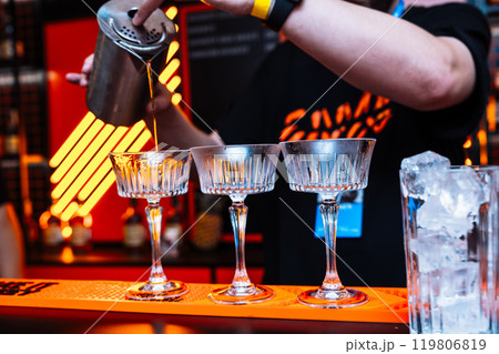 Preparing unique cocktails with precision at an alcohol tasting event 119806819