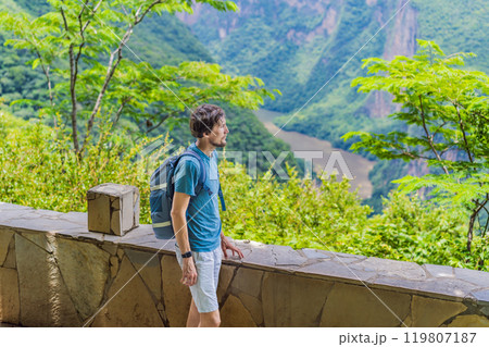 Male tourist exploring Sumidero Canyon National Park, Mexico. Adventure, natural exploration, and travel experience concept 119807187