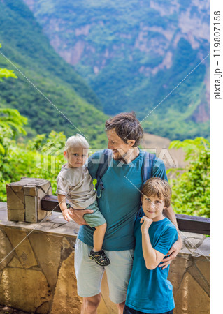 Dad and his two sons baby and teenager travelers exploring Sumidero Canyon National Park, Mexico. Adventure, natural exploration, and travel experience concept Dad and his two sons baby and teenager travelers exploring Sumidero Canyon National Park, Mexico. Adventure, natural exploration, and travel experience concept 119807188