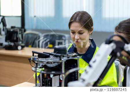 Female using tablet staff engineer with robot for education at class room. Education for future robotics learning innovation. Workshop maintenance technical. 119807245