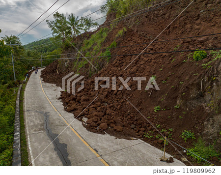 Heavy rainfall cause the landslides that block the half of the road. Camiguin, Philippines. Heavy rainfall cause the landslides that block the half of the road. Camiguin, Philippines. 119809962