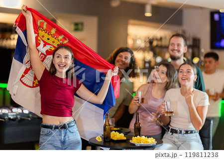 Joyful fans of Serbian team celebrate victory - they raise Serbian flag Joyful fans of Serbian team celebrate victory - they raise Serbian flag 119811238