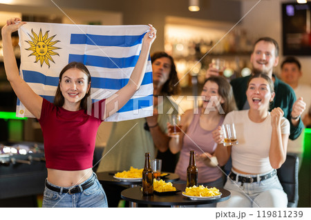 Group of fans in bar with Uruguayan flag Group of fans in bar with Uruguayan flag 119811239