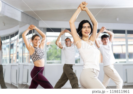 Smiling brunette enjoying passionate flamenco in dance studio 119811961