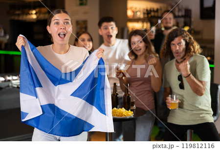 Group of fans in bar with Scottish flag Group of fans in bar with Scottish flag 119812116