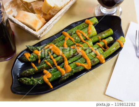 Grilled green asparagus with Romesk sauce 119812282