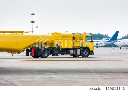 Yellow tank truck aircraft refueler at the airport apron Yellow tank truck aircraft refueler at the airport apron 119813148