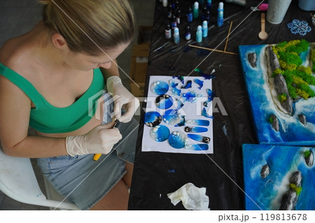 The process of making the art decor of epoxy resin, natural stones and moss 119813678