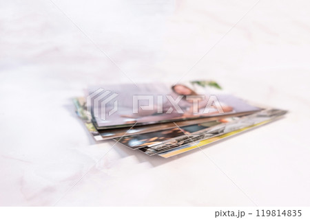 woman sitting at desk and looking at printed photos, remember nostalgia for a day of rest. photography cards, background. Mock up woman sitting at desk and looking at printed photos, remember nostalgia for a day of rest. photography cards, background. Mock up 119814835