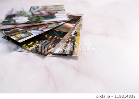 woman sitting at desk and looking at printed photos, remember nostalgia for a day of rest. photography cards, background. Mock up woman sitting at desk and looking at printed photos, remember nostalgia for a day of rest. photography cards, background. Mock up 119814838
